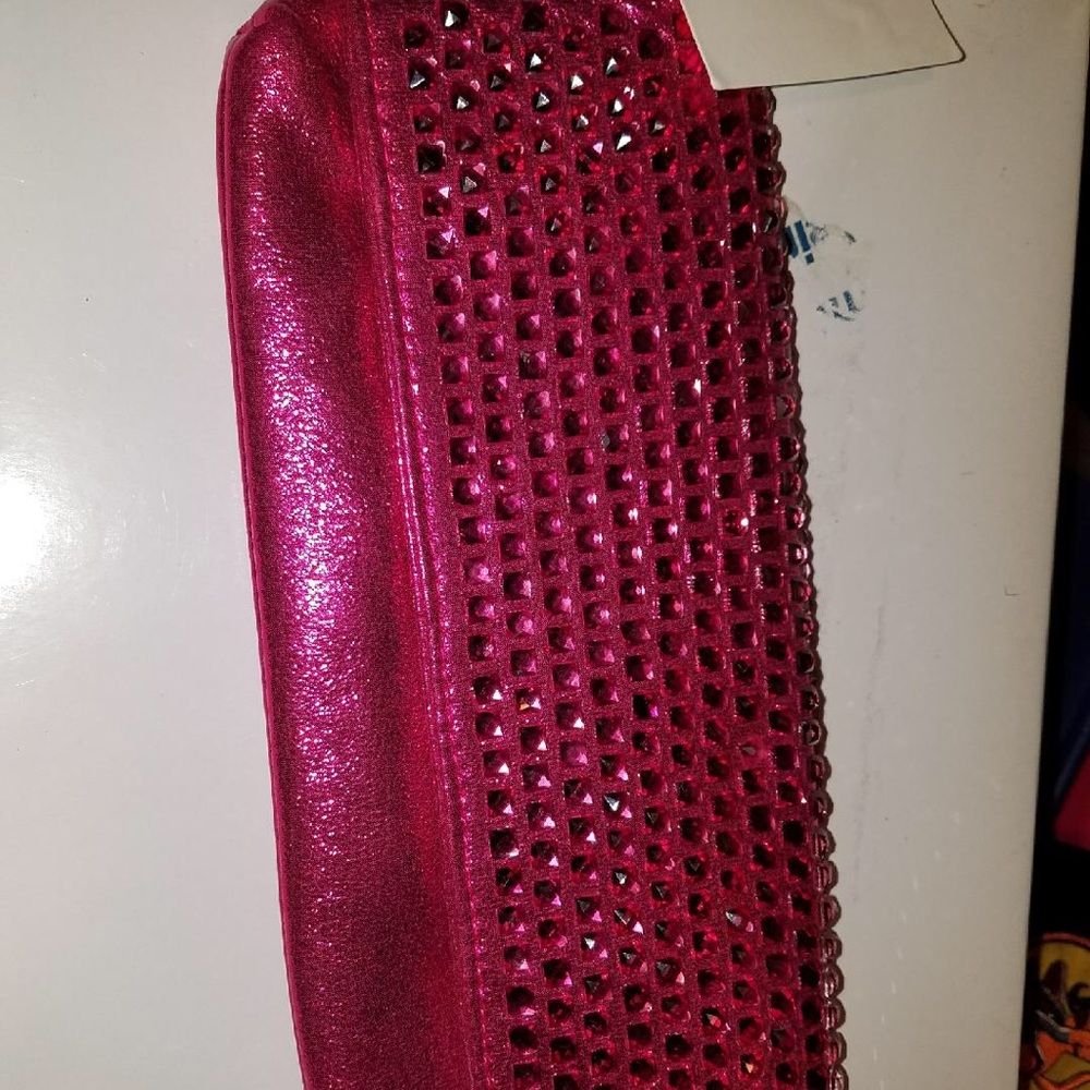 Pink colored clutch with rhinestone details